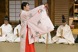 Shrine maiden performs a ceremonial dance.